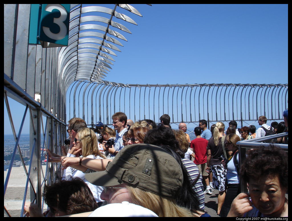 crowd on the 86th floor of the Empire State Building